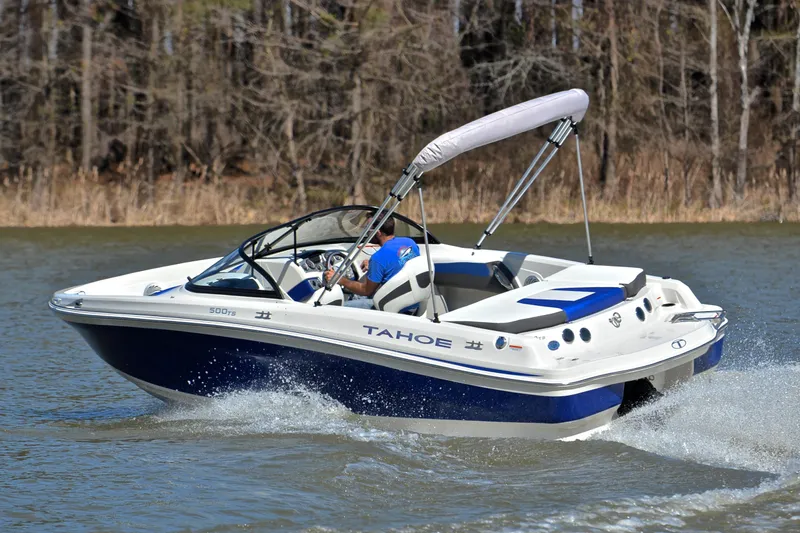 Slide: The Image of 2015 Tahoe 500 TS boat cruising on a lake with trees in the background. - 5