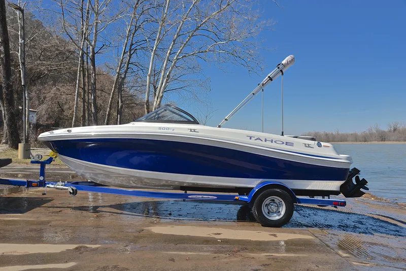 Slide: The Image of 2015 Tahoe 500 TS boat on trailer by lake, clear blue sky. - 9
