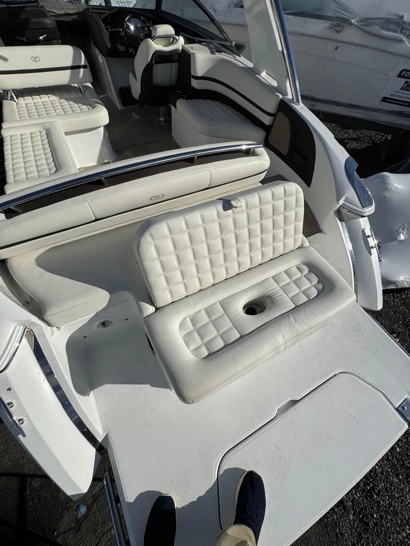 Slide: The Image of 2018 Cobalt R7 boat interior with white cushioned seating and sleek design. - 10