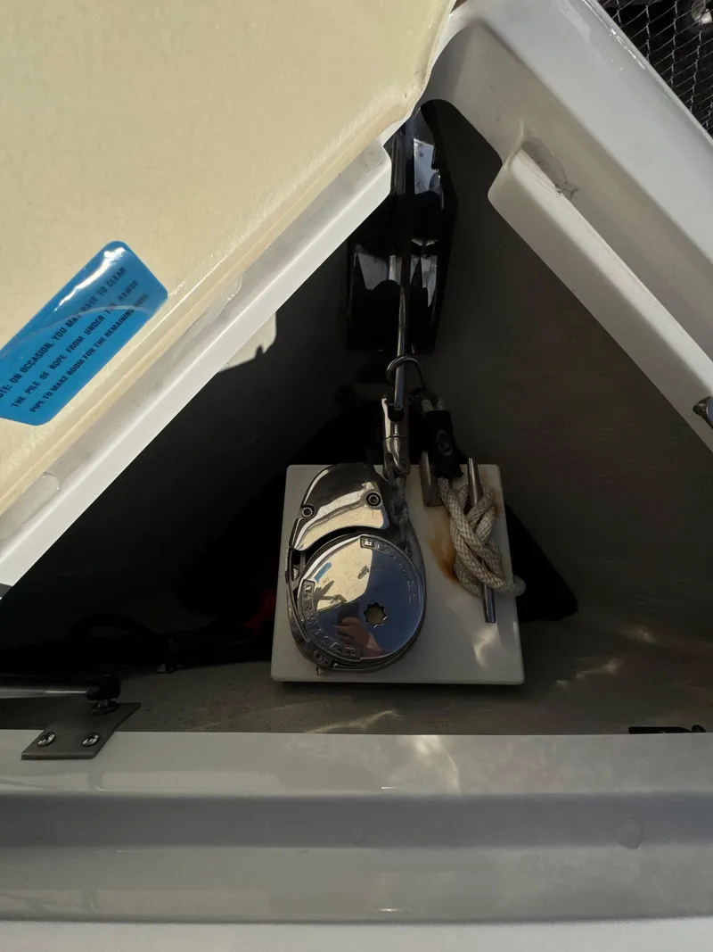 Slide: The Image of 2018 Cobalt R7 boat anchor compartment with rope and winch. - 11