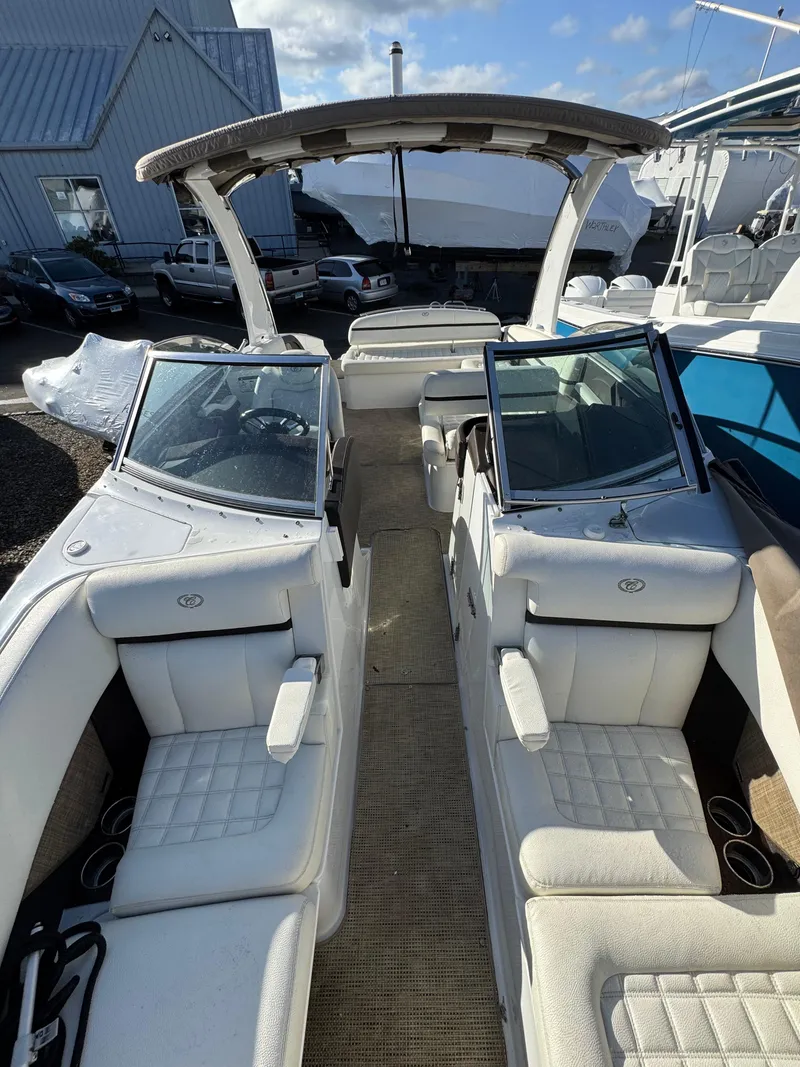 Slide: The Image of 2018 Cobalt R7 boat with white seating and open deck, docked near other boats. - 12