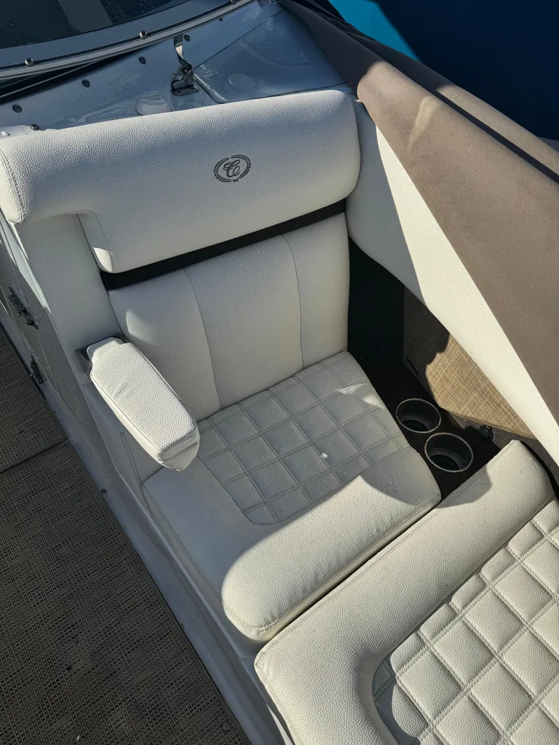 Slide: The Image of 2018 Cobalt R7 boat interior with white cushioned seating and cup holders. - 13
