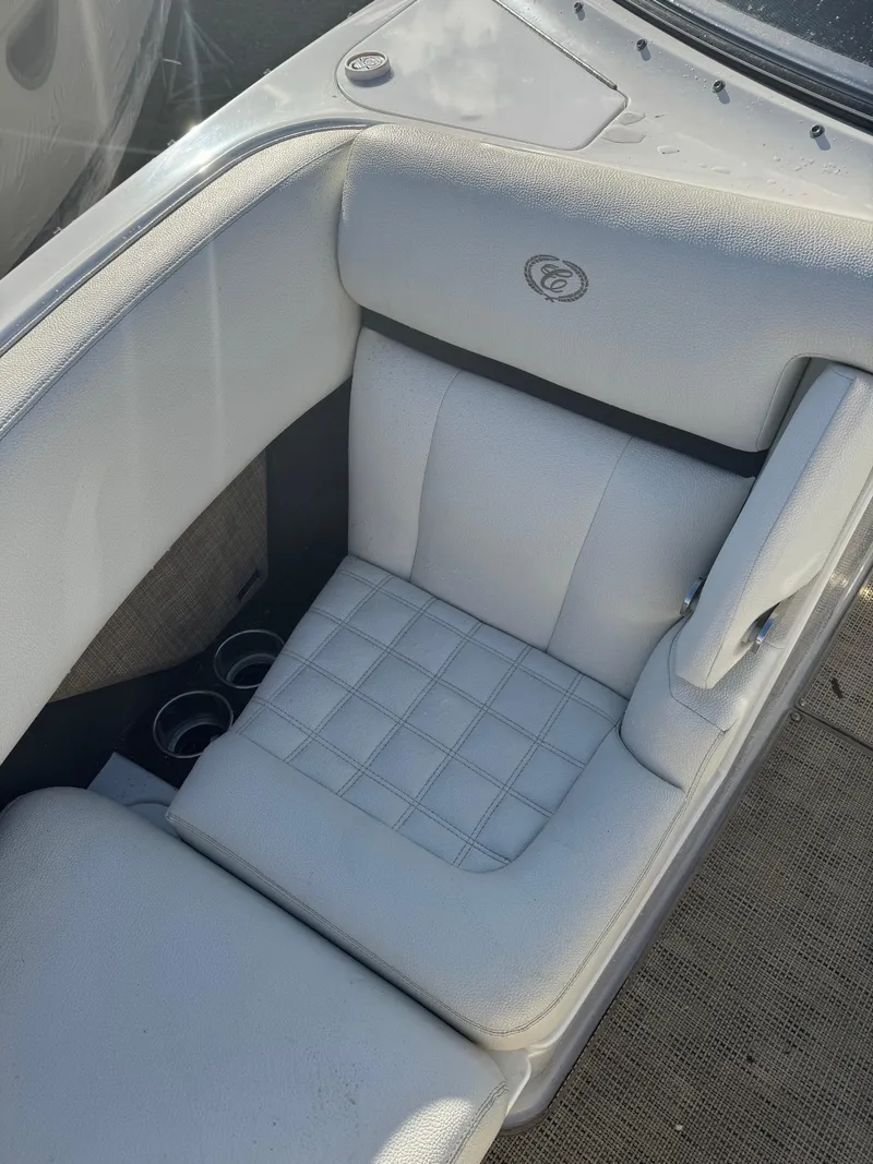 Slide: The Image of 2018 Cobalt R7 boat interior with white cushioned seating and cup holders. - 15