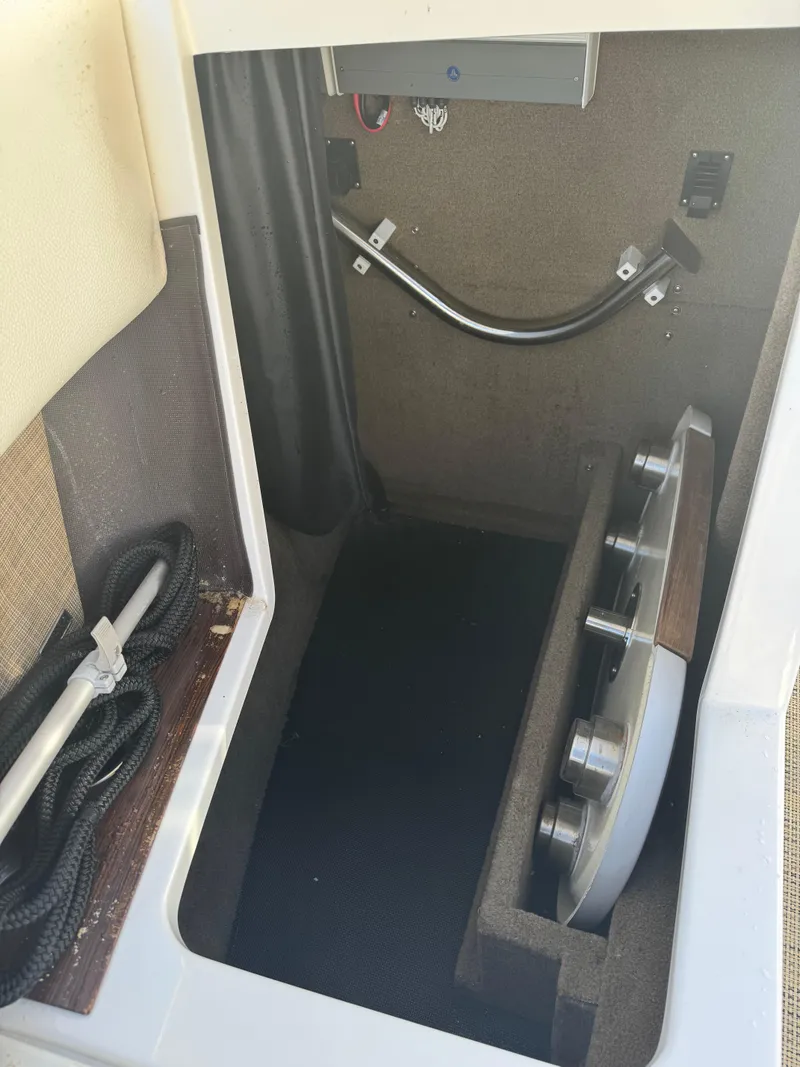 Slide: The Image of 2018 Cobalt R7 boat storage compartment with ropes and metal fittings. - 16
