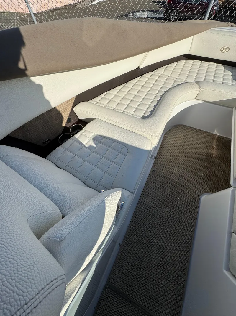 Slide: The Image of 2018 Cobalt R7 boat interior with quilted white leather seating and carpeted flooring. - 17