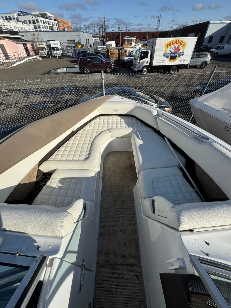 Slide: The Image of 2018 Cobalt R7 boat with spacious seating, parked in an industrial area. - 18