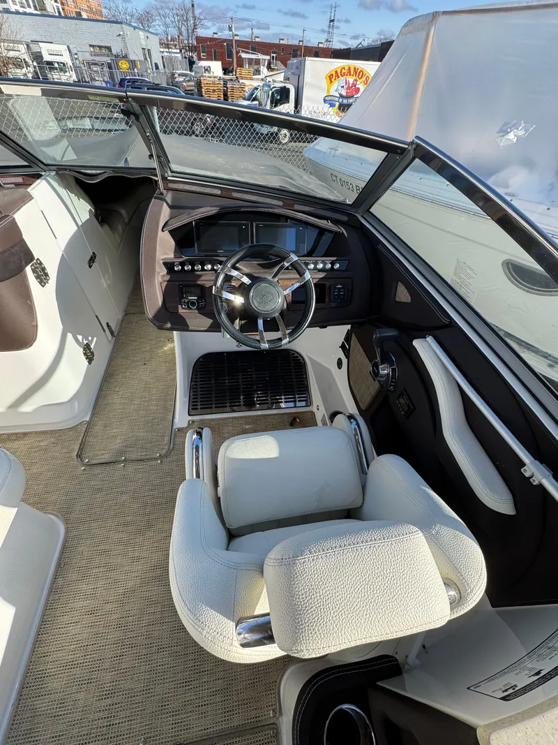 Slide: The Image of 2018 Cobalt R7 boat interior with steering wheel and seating, showcasing luxury design. - 21