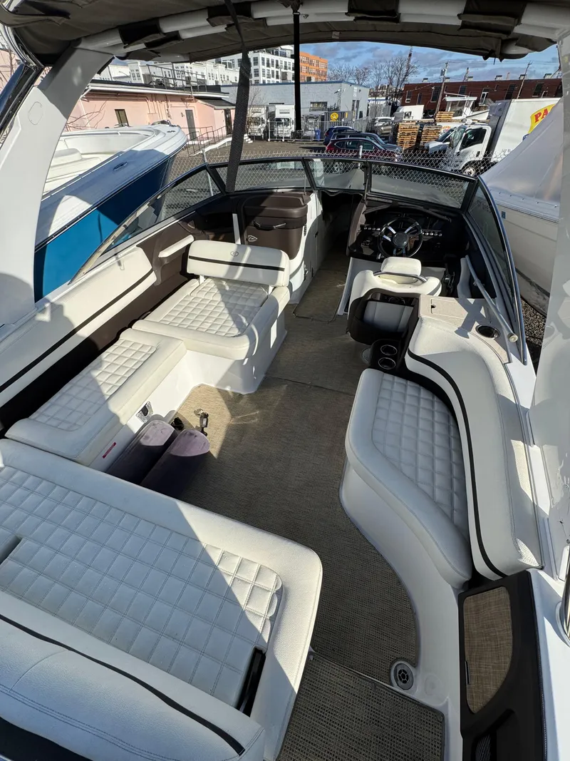 Slide: The Image of 2018 Cobalt R7 boat interior with white seating and modern dashboard. - 22