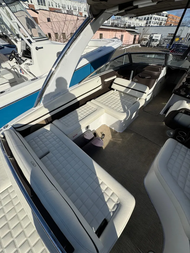 Slide: The Image of 2018 Cobalt R7 boat interior with white quilted seating and modern design. - 23