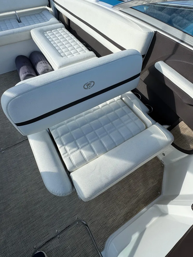 Slide: The Image of 2018 Cobalt R7 boat interior with white cushioned seating and carpeted flooring. - 24