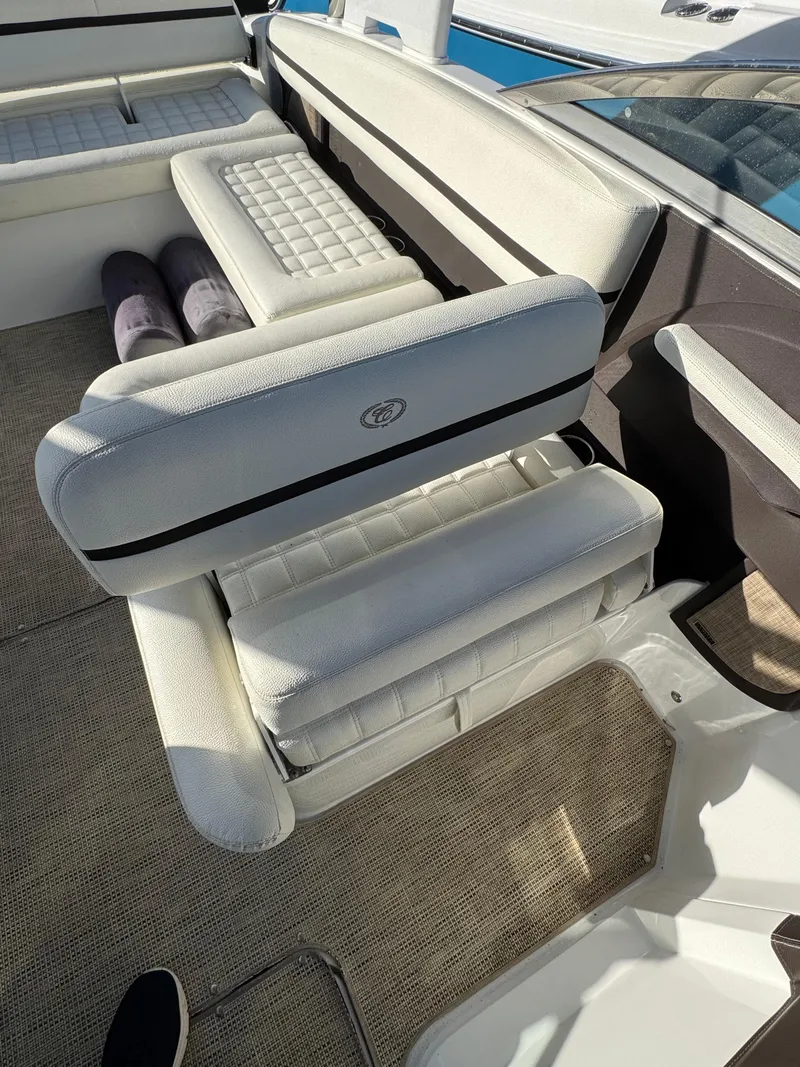Slide: The Image of 2018 Cobalt R7 boat interior with white cushioned seating and carpeted flooring. - 25