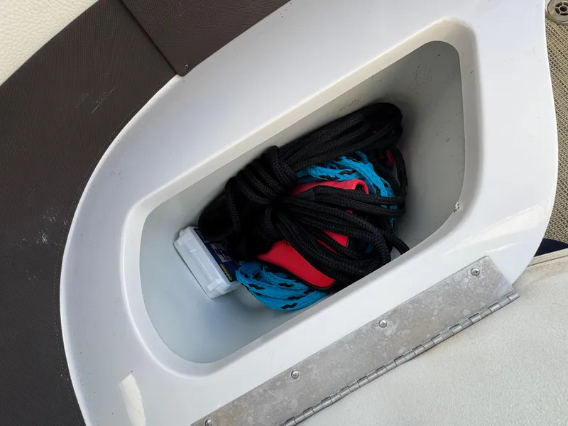 Slide: The Image of Storage compartment in 2018 Cobalt R7 boat with coiled rope and gear. - 27