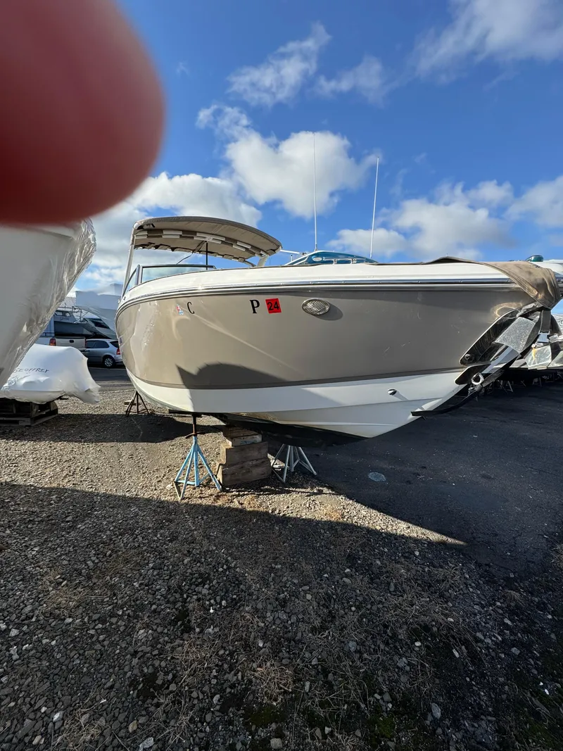 Slide: The Image of 2018 Cobalt R7 boat on stands, under a clear blue sky. - 3
