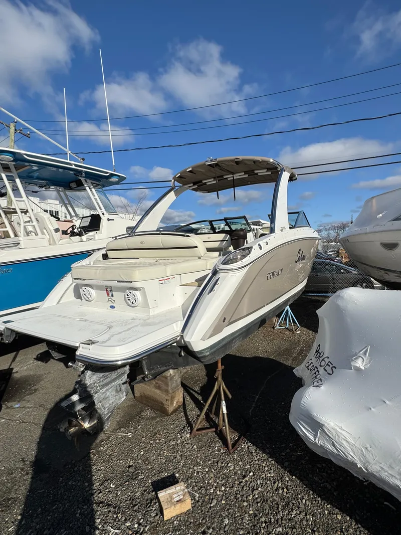 Slide: The Image of 2018 Cobalt R7 boat on display in a marina under a clear blue sky. - 6