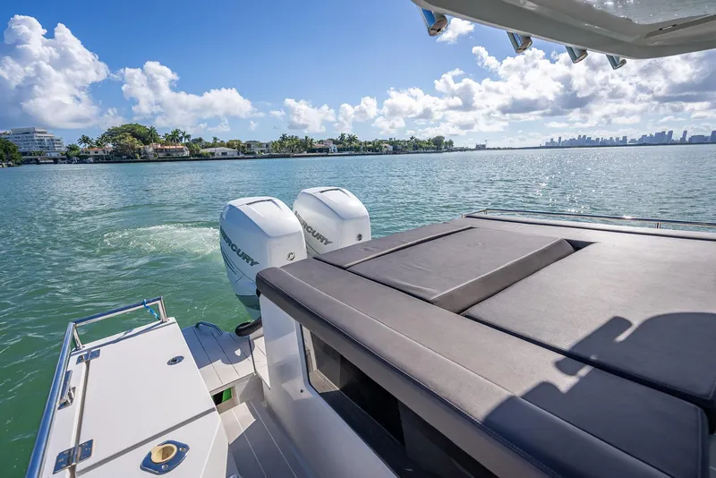 Slide: The Image of 2017 Axopar 37 XC Cross Cabin on water, featuring dual outboard engines. - 17