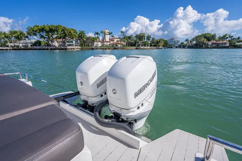 Slide: The Image of Axopar 37 XC Cross Cabin 2017 with twin Mercury outboard engines on a scenic waterway. - 21