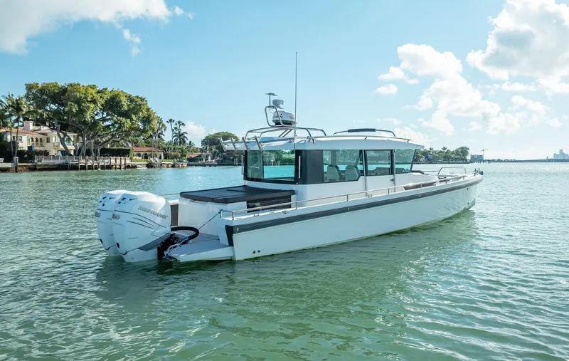 Slide: The Image of 2017 Axopar 37 XC Cross Cabin boat on calm water, sunny day. - 5
