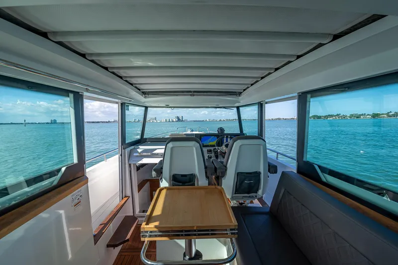 Slide: The Image of Interior of 2017 Axopar 37 XC Cross Cabin, featuring panoramic windows and modern seating. - 8