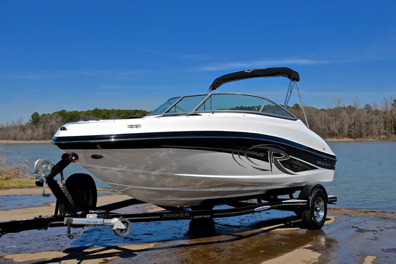 Slide: The Image of 2014 Rinker 196 Captiva boat on trailer by a lake. - 10