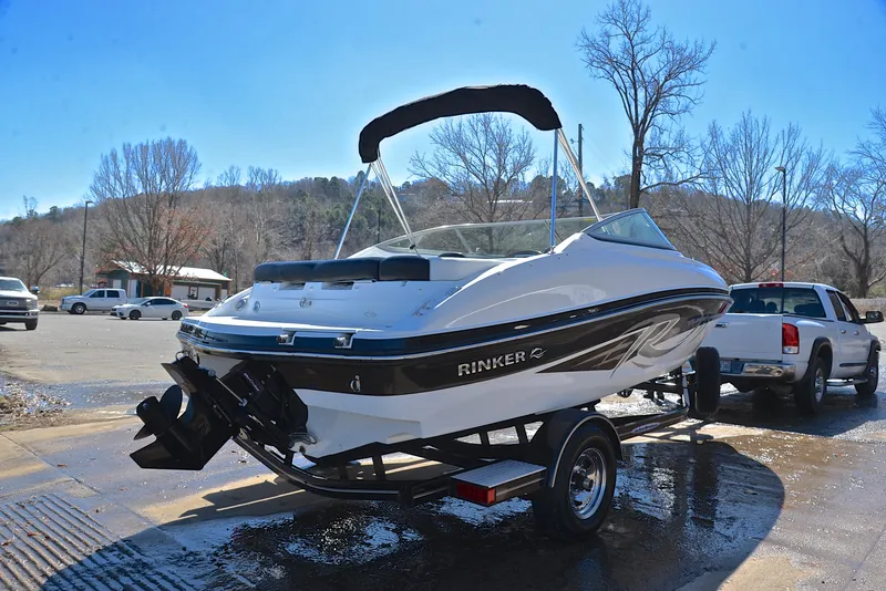 Slide: The Image of 2014 Rinker 196 Captiva boat on trailer in sunny outdoor setting. - 14