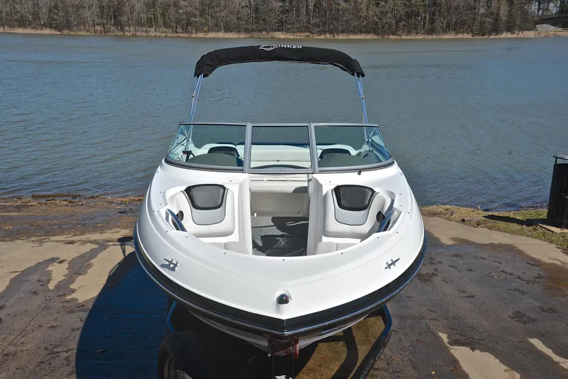 Slide: The Image of 2014 Rinker 196 Captiva boat on a trailer by a lake. - 17