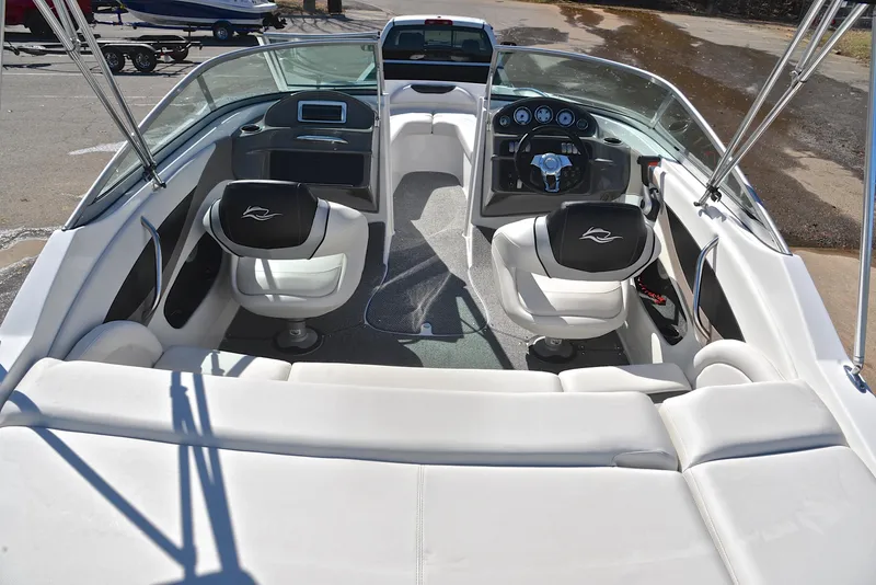 Slide: The Image of 2014 Rinker 196 Captiva boat interior with white seating and modern dashboard. - 18