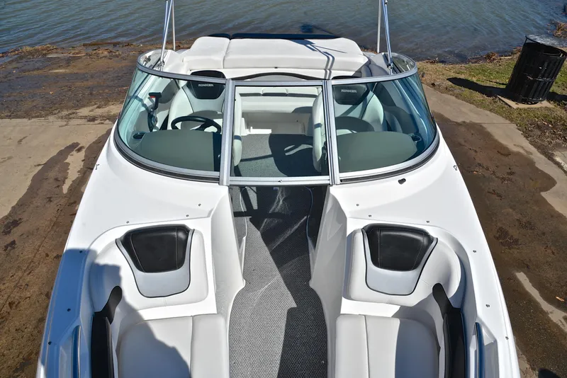 Slide: The Image of 2014 Rinker 196 Captiva boat, white interior, docked by the water. - 20