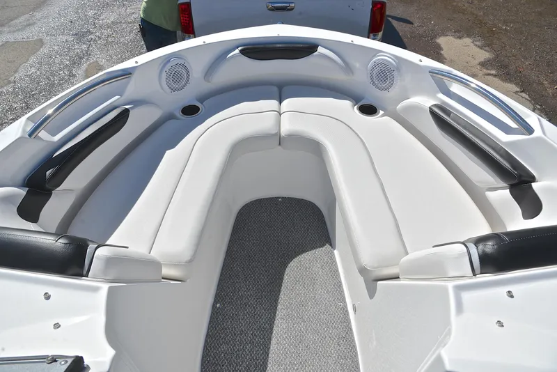 Slide: The Image of 2014 Rinker 196 Captiva boat interior with white seating and cup holders. - 21