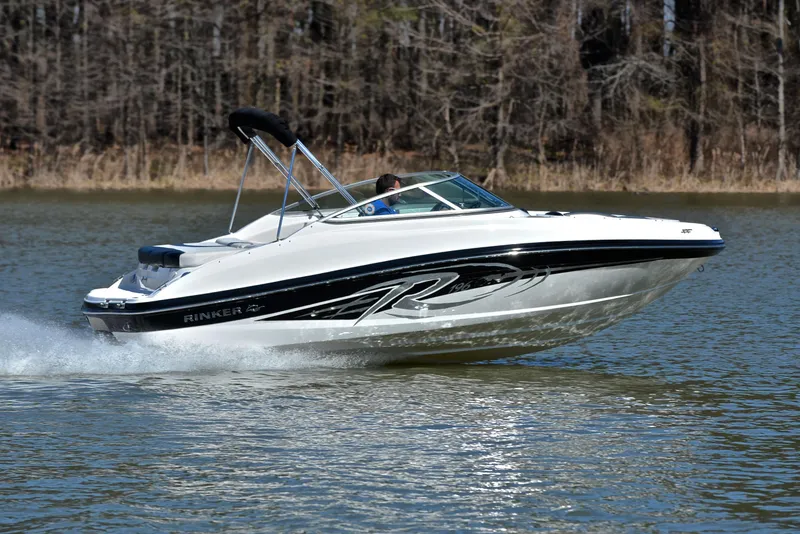 Slide: The Image of 2014 Rinker 196 Captiva speedboat cruising on a lake with forested background. - 3