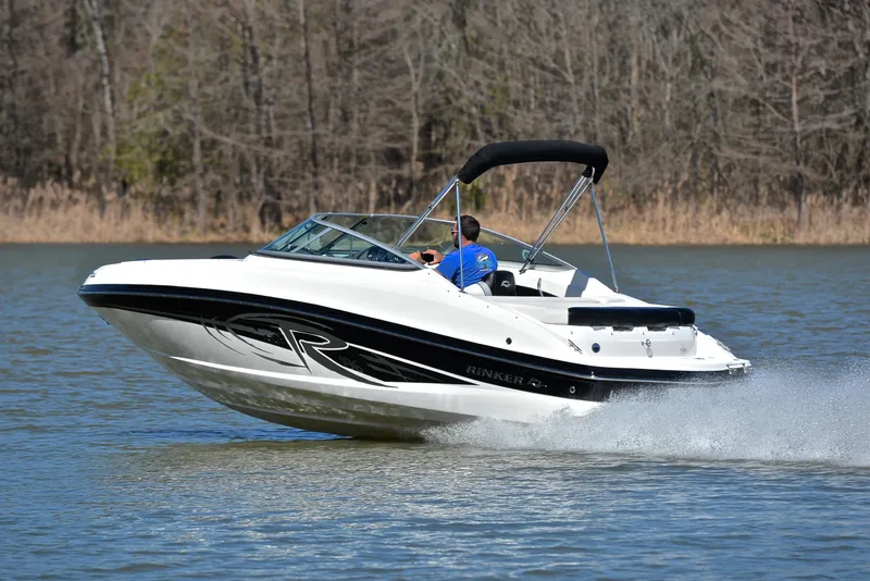 Slide: The Image of 2014 Rinker 196 Captiva speedboat cruising on a lake with trees in the background. - 4