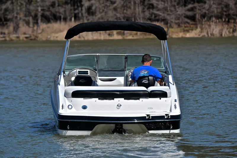 Slide: The Image of 2014 Rinker 196 Captiva boat on a lake, rear view with driver. - 8
