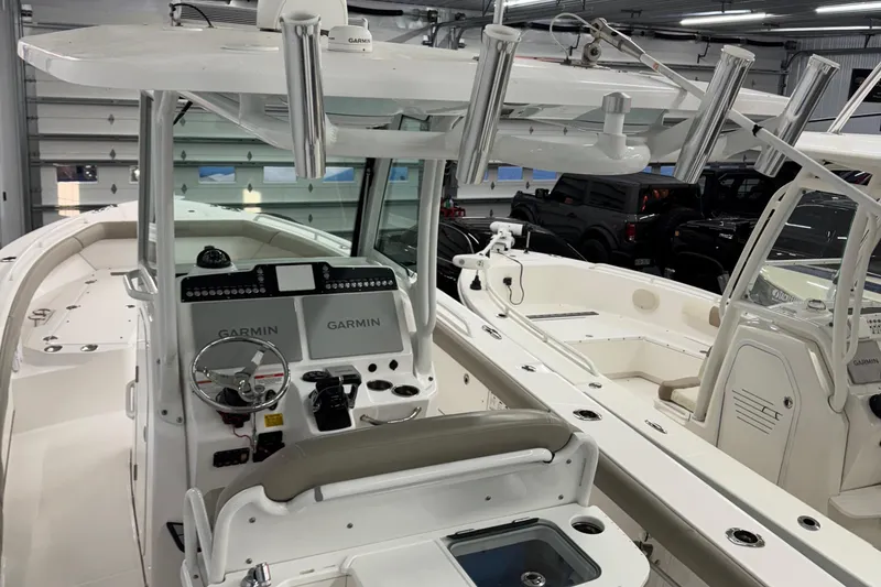 Slide: The Image of 2019 Everglades 273 Center Console boat interior with Garmin electronics in a showroom. - 3