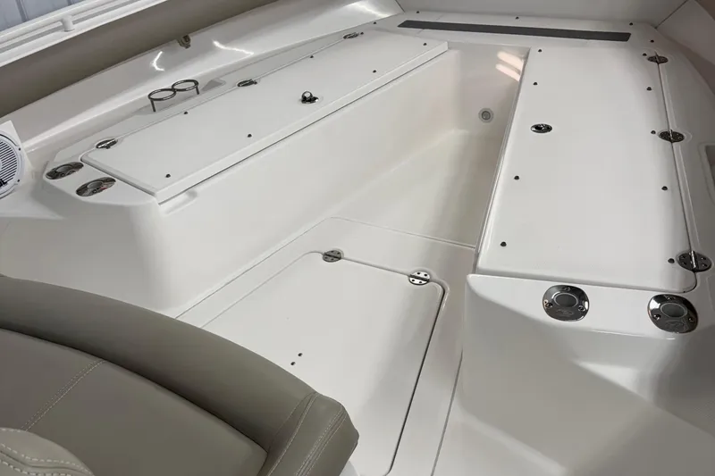 Slide: The Image of 2019 Everglades 273 Center Console boat interior with white seating and storage compartments. - 6