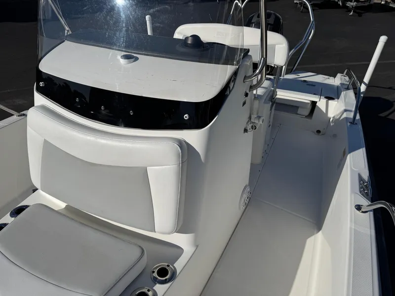 Slide: The Image of 2014 Boston Whaler 210 Dauntless boat interior with console and seating. - 10