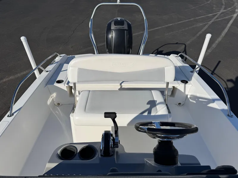 Slide: The Image of 2014 Boston Whaler 210 Dauntless boat interior with steering wheel and seating. - 11