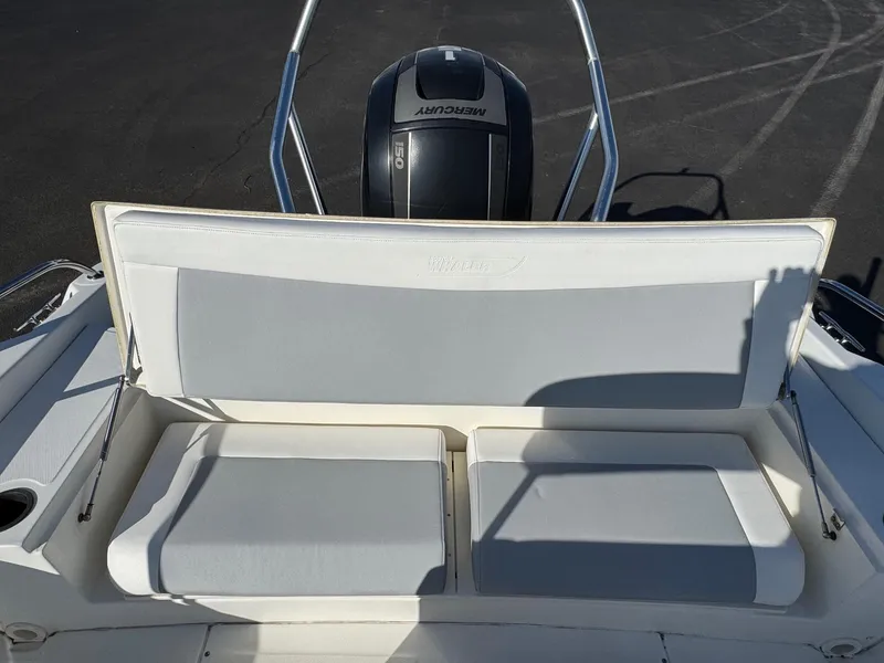 Slide: The Image of 2014 Boston Whaler 210 Dauntless boat seating with Mercury engine in background. - 15