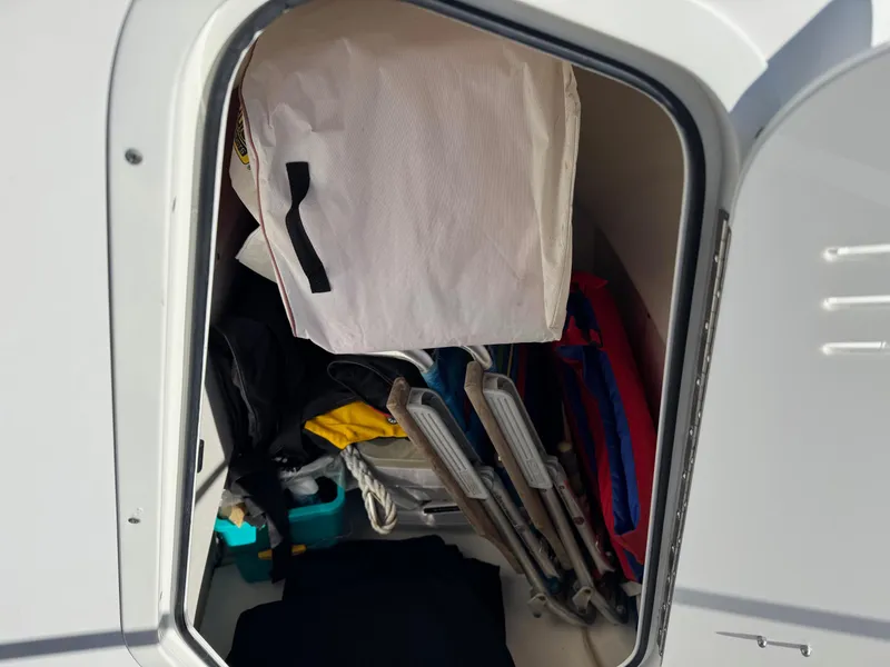 Slide: The Image of Storage compartment of 2014 Boston Whaler 210 Dauntless, filled with boating gear. - 17