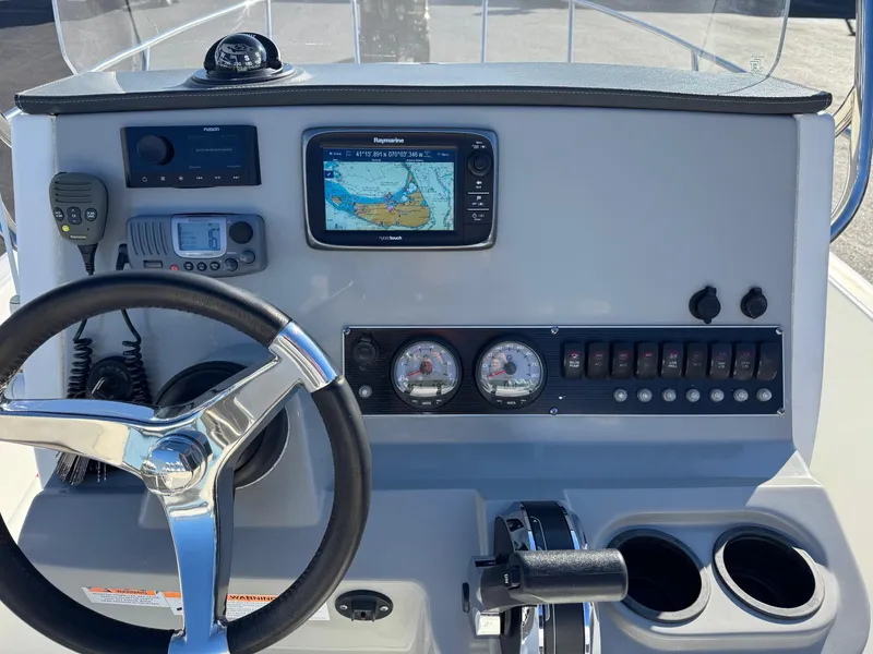 Slide: The Image of Boston Whaler 210 Dauntless 2014 dashboard with navigation system and controls. - 18
