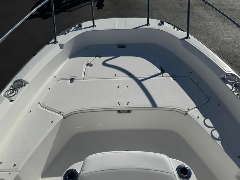 Slide: The Image of 2014 Boston Whaler 210 Dauntless boat deck with seating and storage compartments. - 6