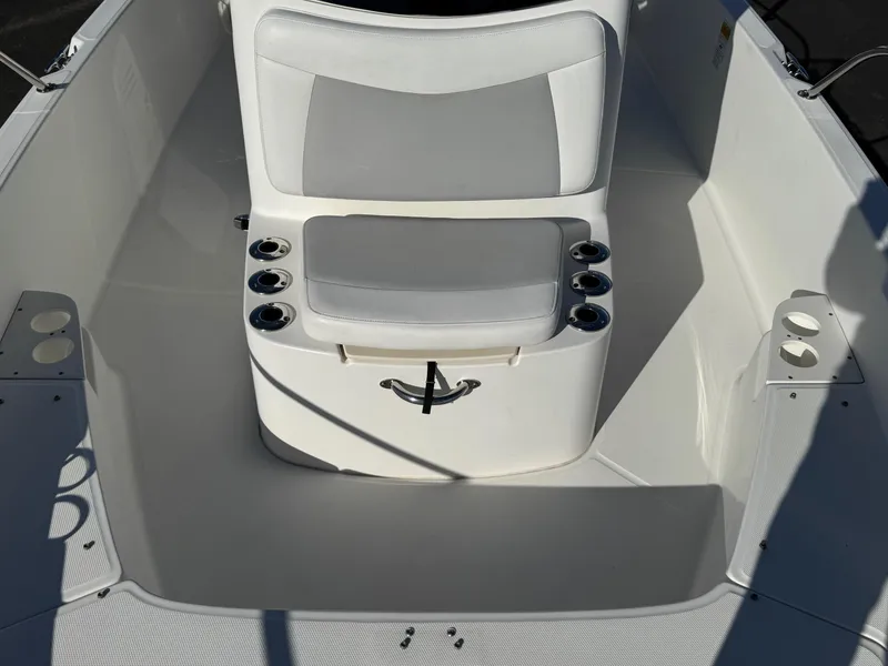 Slide: The Image of 2014 Boston Whaler 210 Dauntless boat interior with seating and cup holders. - 8
