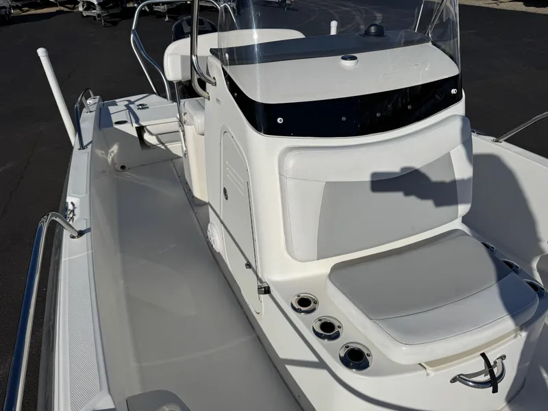 Slide: The Image of 2014 Boston Whaler 210 Dauntless boat interior with seating and console. - 9