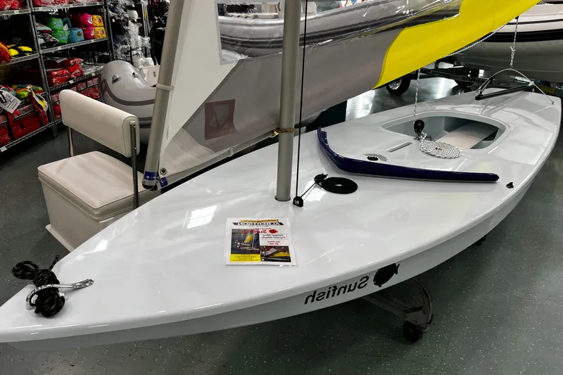 Slide: The Image of 2024 Sunfish Laser sailboat displayed indoors, featuring sleek design and vibrant sail. - 4