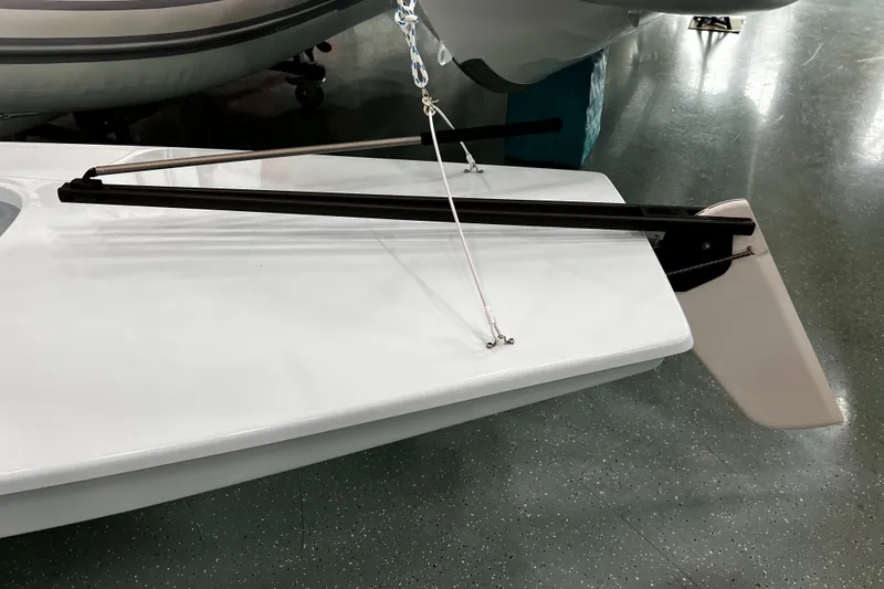 Slide: The Image of 2024 Sunfish/Laser sailboat with rudder and tiller on display. - 8