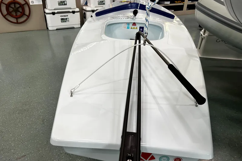 Slide: The Image of 2024 Sunfish Laser sailboat displayed indoors, showcasing sleek design and rigging. - 9