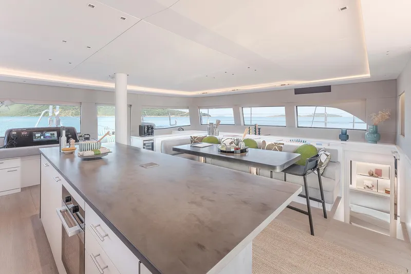 Slide: The Image of Luxurious interior of 2025 Lagoon SIXTY 5 yacht with modern kitchen and panoramic windows. - 14