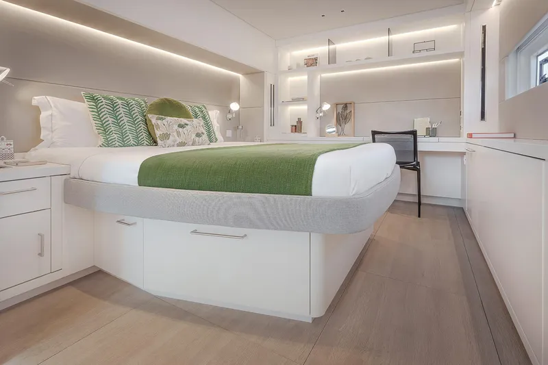 Slide: The Image of Luxurious bedroom interior of 2025 Lagoon SIXTY 5 yacht with modern design and elegant furnishings. - 21