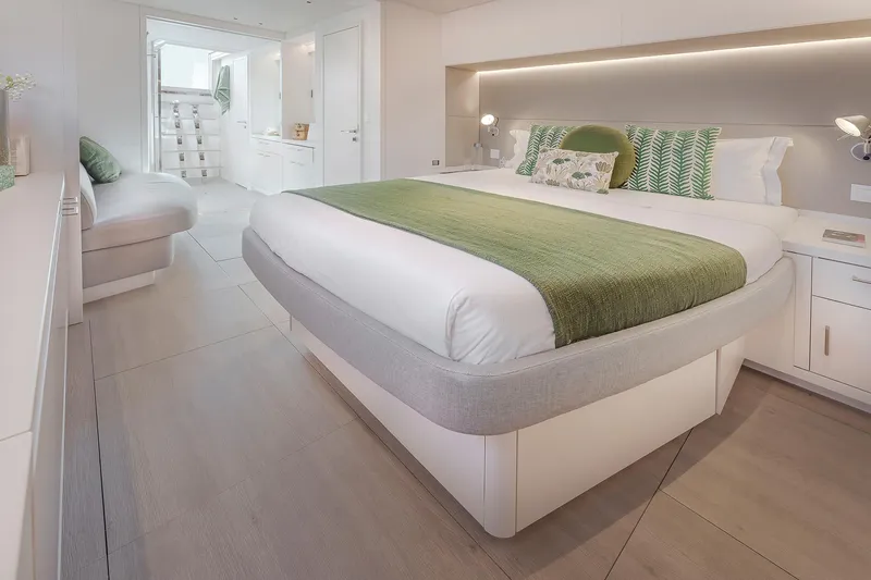 Slide: The Image of Luxurious bedroom interior of 2025 Lagoon SIXTY 5 yacht with modern design and green accents. - 23