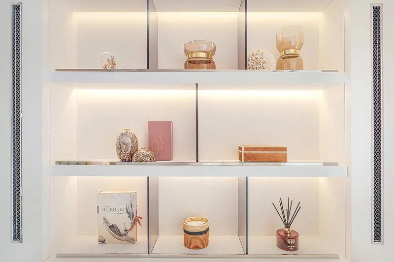 Slide: The Image of Elegant shelving with decorative items on a Lagoon SIXTY 5, 2025 model yacht. - 24