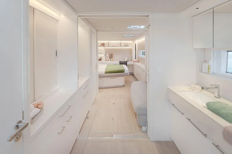 Slide: The Image of Luxurious interior of 2025 Lagoon SIXTY 5 yacht, featuring modern bedroom and bathroom design. - 26