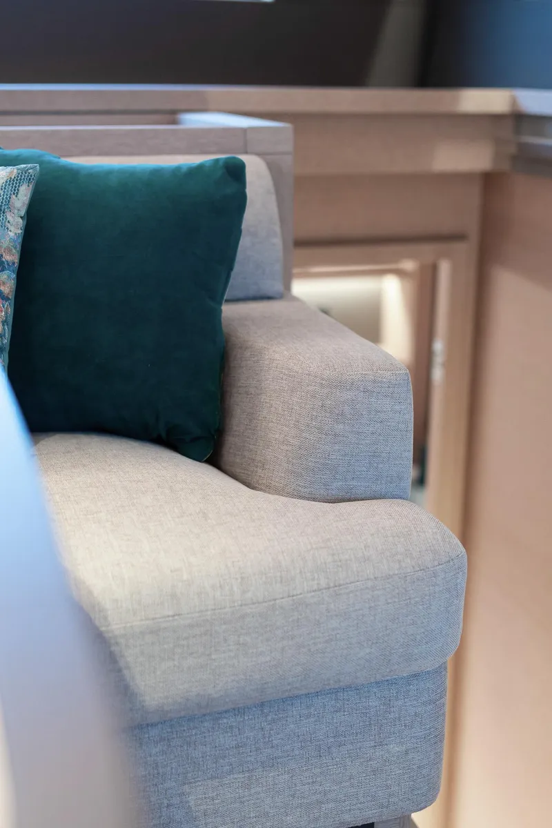 Slide: The Image of Luxurious interior of 2025 Lagoon SIXTY 5 yacht with plush seating and teal cushion. - 38